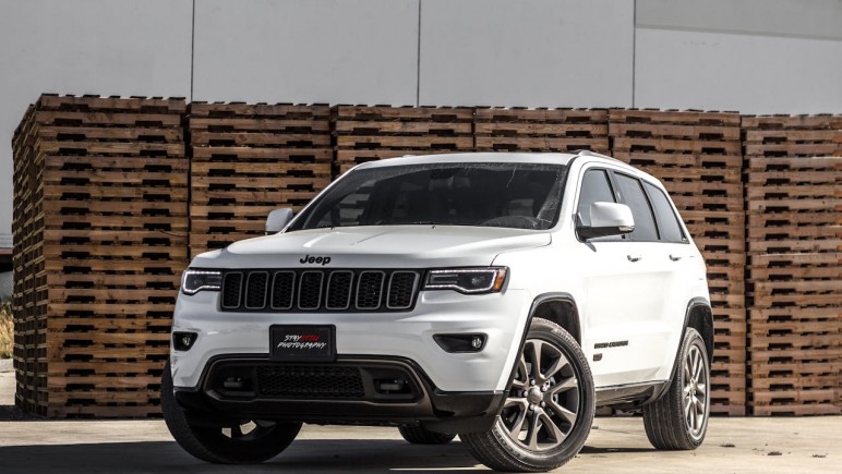 WHITE JEEP CHEROKEE SUV NEAR STACKED BROWN PALLET BOARDS