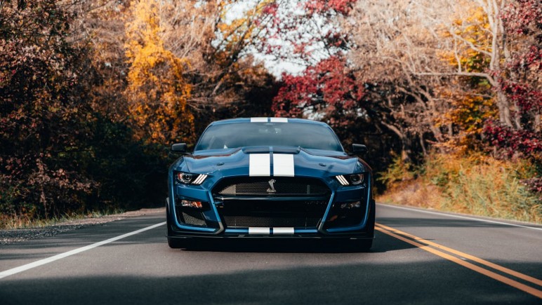 PHOTO OF BLUE MUSTANG ON ROAD FORD