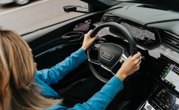 WOMAN DRIVING A NEW AUDI CAR