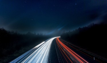LIGHT TRAILS FROM CARS DRIVING ON THE ROAD