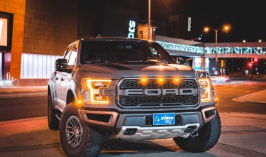 FORD CAR PARKED ON CITY STREET AT NIGHT 