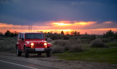 RED JEEP SUV BESIDE ROAD