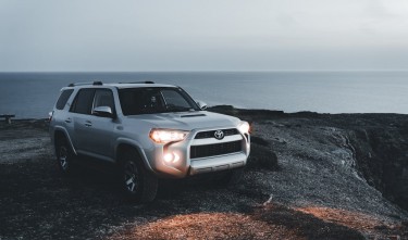 A TOYOTA 4 RUNNER PARKED ON THE SHORE 