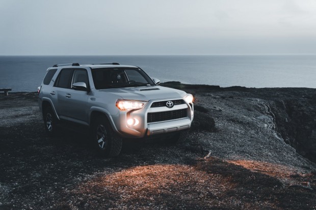 A TOYOTA 4 RUNNER PARKED ON THE SHORE 
