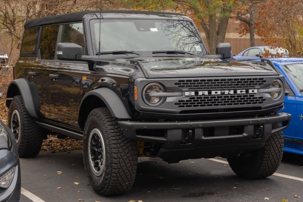 A BLACK VEHICLE PARKED FORD BRONCO