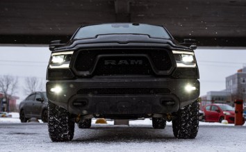 LOW ANGLE SHOT OF A BLACK RAM PICKUP TRUCK ON A PARKING LOT 