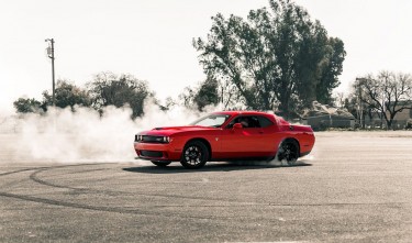 RED COUPE DRIFTING ON ASPHALT ROAD 