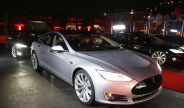 Tesla third-quarter loss doubles to $75 million, shares jump