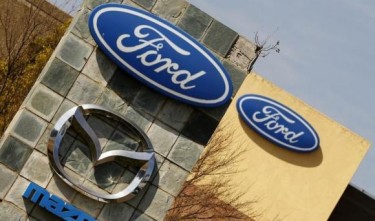 Ford shares tumble on lower profit outlook for 2014-2015
