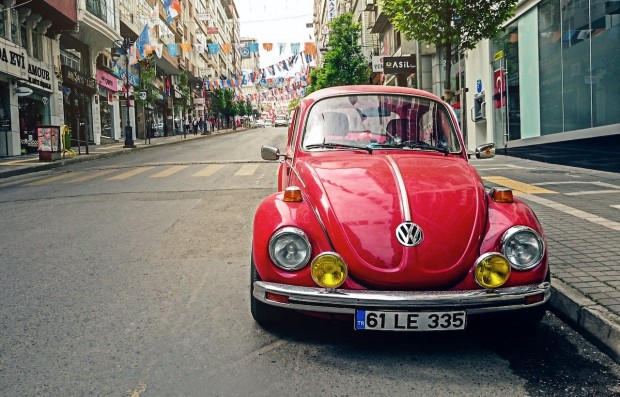 Red Beetle parked at the roadside near pedestrian lane 