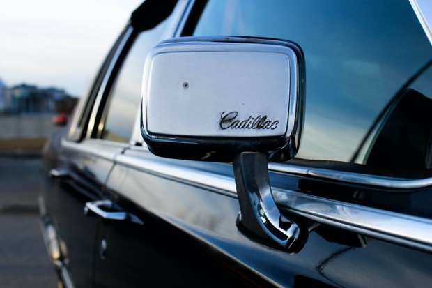 BLACK CADILLAC WITH CHROME SIDE MIRROR