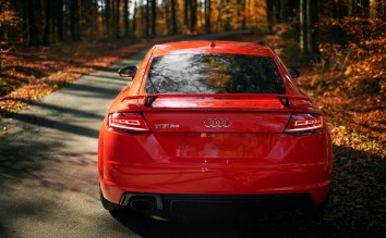 RED AUDI DRIVING THROUGH THE AUTUMAL FOREST 
