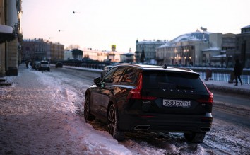 CAR PARKED IN SNOW BY SIDEWALK
