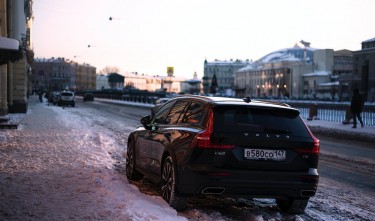 CAR PARKED IN SNOW BY SIDEWALK