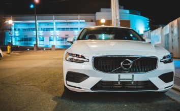 PHOTO OF WHITE CAR PARKED ON ROAD SIDE VOLVO