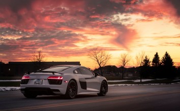 A WHITE SPORTS CAR ON THE ROAD  AUDI